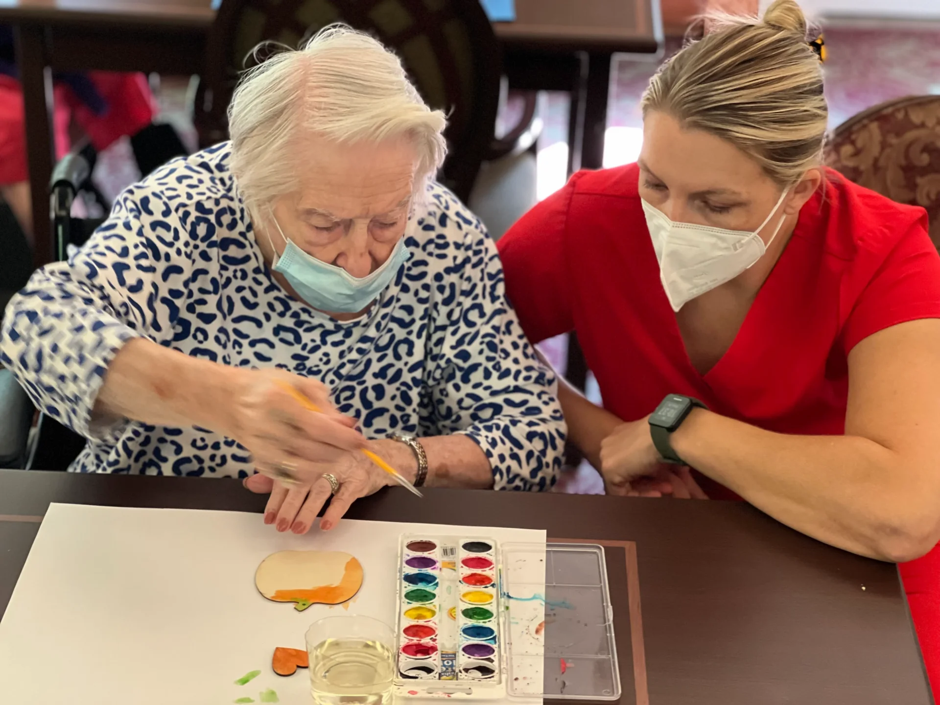 Rehab Staff Crouching Beside A Patient Painting A Craft Image Image
